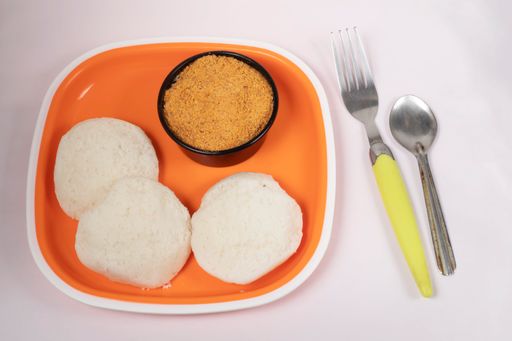 A closeup shot of Indian Idli food on an orange plate