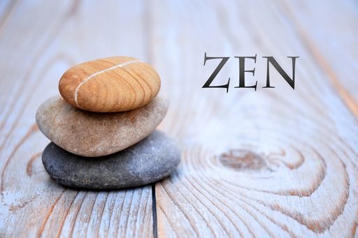 A closeup of flat stones on each other on the table with [ZEN] written on it