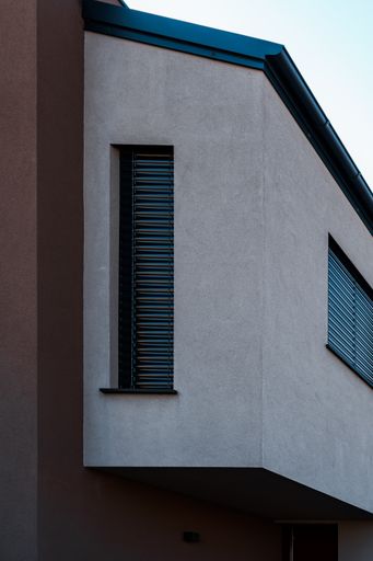 A vertical shot of the modern exterior of a house during the day