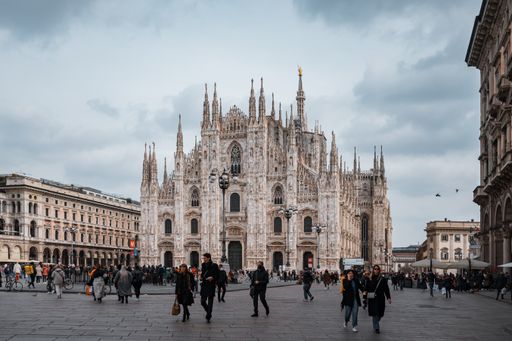 The Milan Cathedral in Italy and tourists visiting the church on a gloomy day