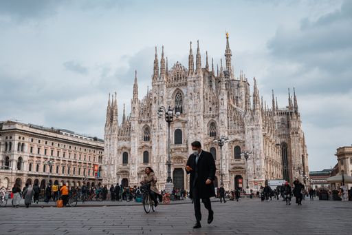 A beautiful cityscape of the Milan Cathedral and people walking in the square in Milan, Italy
