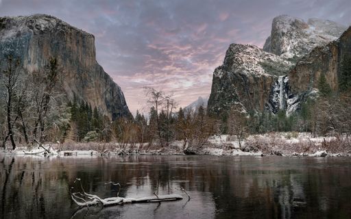 a photo of winter lake surrounded by mountains
