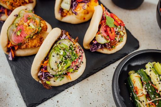 A closeup shot of steamed bao buns on a black surface