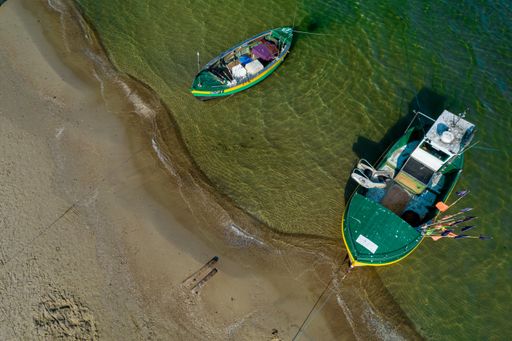 A 90-degree top view from a drone  to a Baltic sea and fishing boats in Sopot, Poland