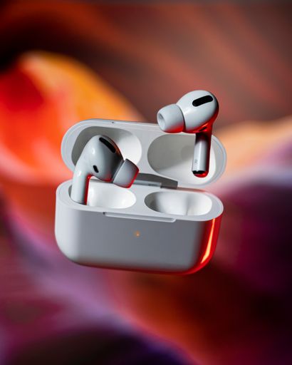 A shallow focus of White wireless earbuds in the case on a shiny blurred background