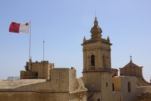 A castle in Malta with the flag waving on top