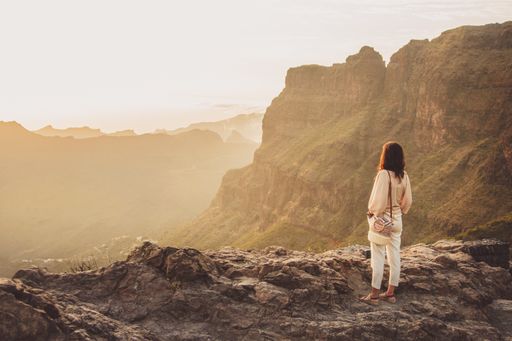 A mesmerizing shot of a female tourist standing at Mirador de Masca Santiago Spain