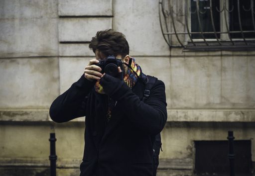 A close up shot of a photographer holding his camera