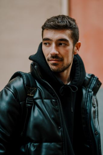 A closeup portrait of a young handsome man on a wall background
