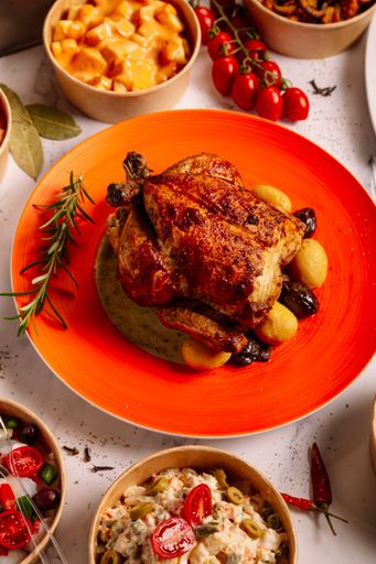 A top view closeup of roasted chicken with baked potatoes