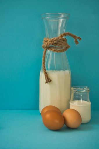 A vertical shot of different dairy products on a blue background