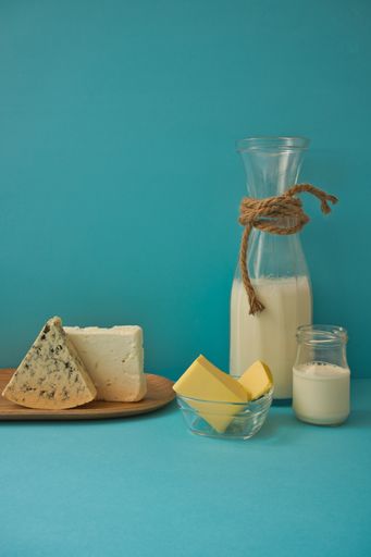 A vertical shot of different dairy products on a blue background