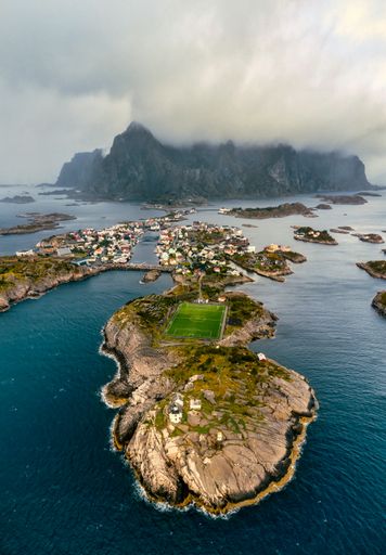 Henningsvaer Lofoten by drone, world famous soccer field, football field. A beautiful fishing village located on the Lofoten, Norway, Nordland region.