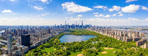 A panoramic aerial view of the Central Park in Manhattan, New York City surrounded by skyscrapers