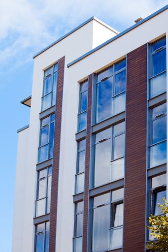 A vertical low angle shot of a modern building under the blue sky