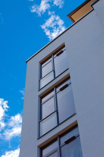 A low angle shot of a modern building under the blue sky