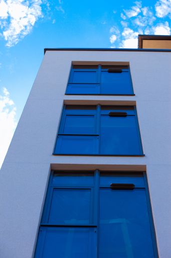 A low angle shot of a modern building under the blue sky