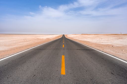 An empty endless road through the desert