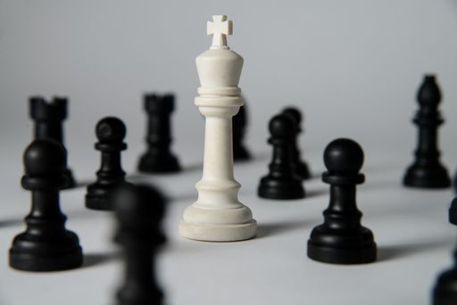 A beautiful composition of black chess figure and a white king in the middle