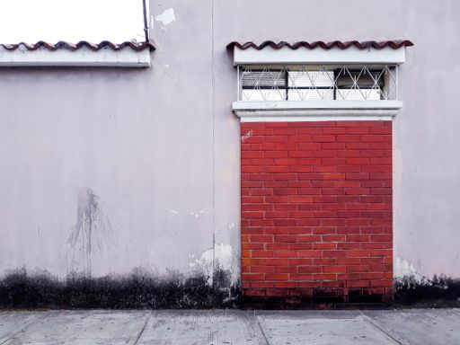 Facade of abandoned house in Guatemala City, Latin America, construction to demolish, urban area