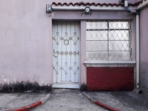 Facade of abandoned house in Guatemala City, Latin America, construction to demolish, urban area