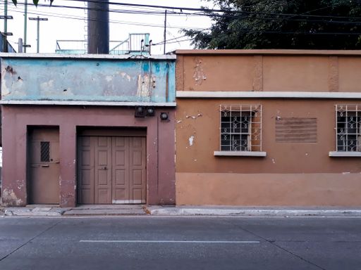 House facades in urban area of Guatemala City at sunset, ocher colors popular homes