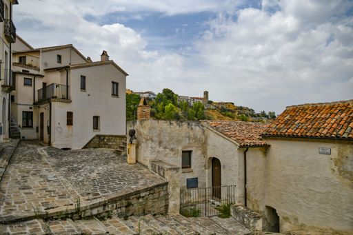A beautiful shot of a narrow street and traditional houses in Aliano village on a sunny day in Basilicata, Italy.