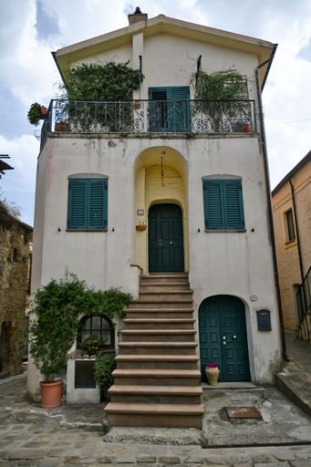 A vertical shot of an old house in Aliano village on a sunny day in Basilicata, Italy.
