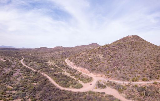 A beautiful shot of a dry Campground in Arizona with dry plants and mountain under cloudy sky