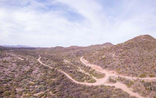 A beautiful shot of a dry Campground in Arizona with dry plants and mountain under cloudy sky