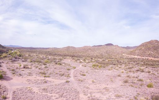 A beautiful shot of a dry Campground in Arizona with dry plants and mountain under cloudy sky