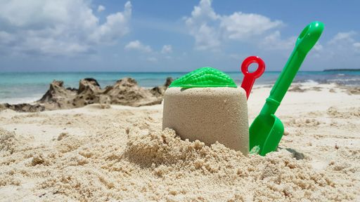 The plastic toys on a sandy beach