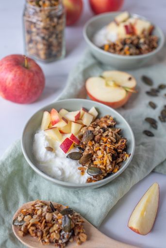 A healthy Easter granola with carrots in a white bowl