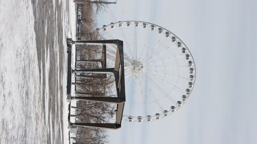 A vertical shot of the Ferris wheel in Montreal in winter on cloudy sky background