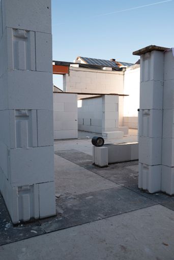 A vertical shot of a construction site of walls made of white blocks