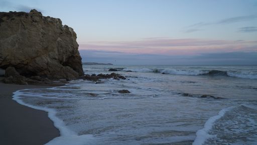 A scenic view of El Matador State Beach during sunset hours