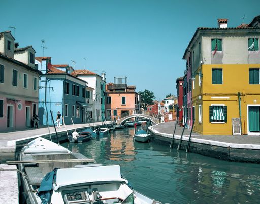 A beautiful shot of boats over a canal in Burano, Venice, Italy