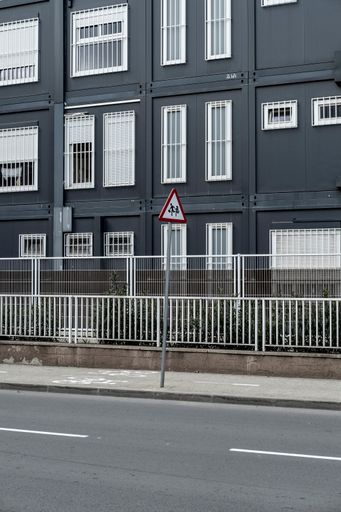 A vertical shot of empty street with building in the background in  Barcelona, Catalonia