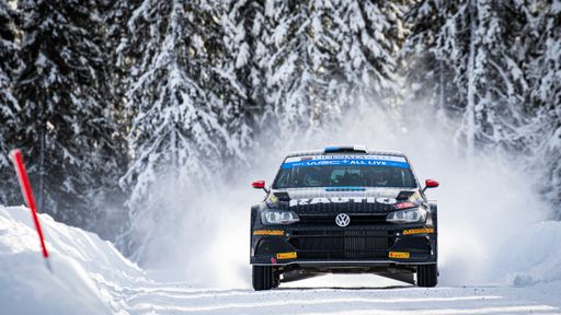 a shot of racing car in snow