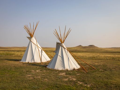 A close-up shot of beautiful two teepees under the sky