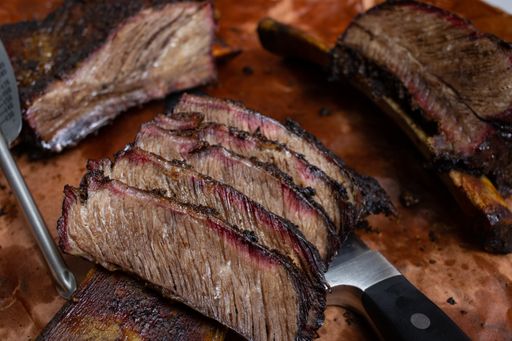 A closeup shot of sliced steak on a wooden surface