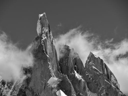 A grayscale shot of the Cerro Torre sharp mountain tops covered in snow on Argentina