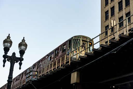 A low angle shot of Chicago metro against blue sky and modern building on a sunny day in Chicago downtown, United States