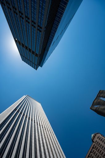 A low angle shot of skyscrapers against blue sky on a sunny day in Chicago downtown, United States
