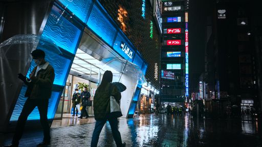 A city night view of the streets with various lights and buildings in Tokyo, Japan