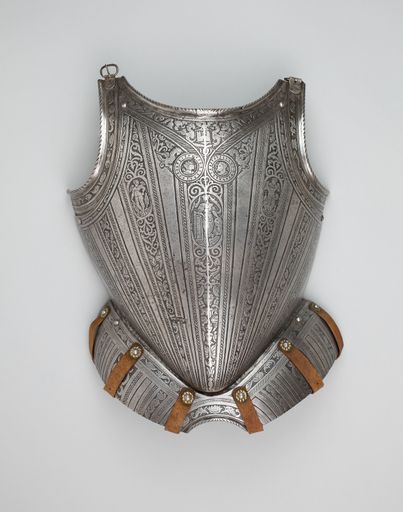 A vertical shot of a medieval knight's armor on a gray background