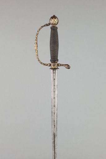 A vertical shot of an antique rusty sword on a white background