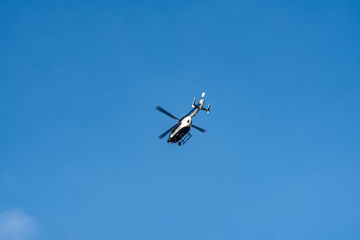 a photo of police helicopter flying against clear sky