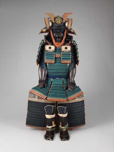 A vertical shot of ancient samurai armor isolated on gray surface background