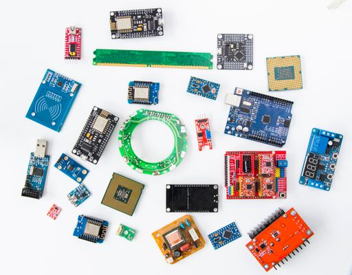 A top view of a CNC shield motherboard, microprocessor, microchips, and wifi development board